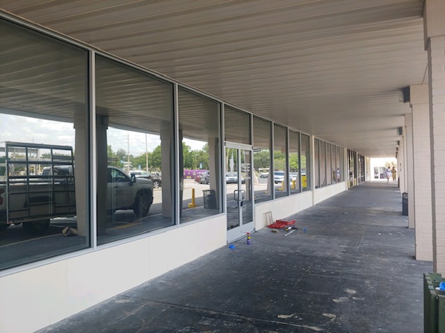 Image of a restaurant patio separated from the main building with large floor to ceiling glass windows