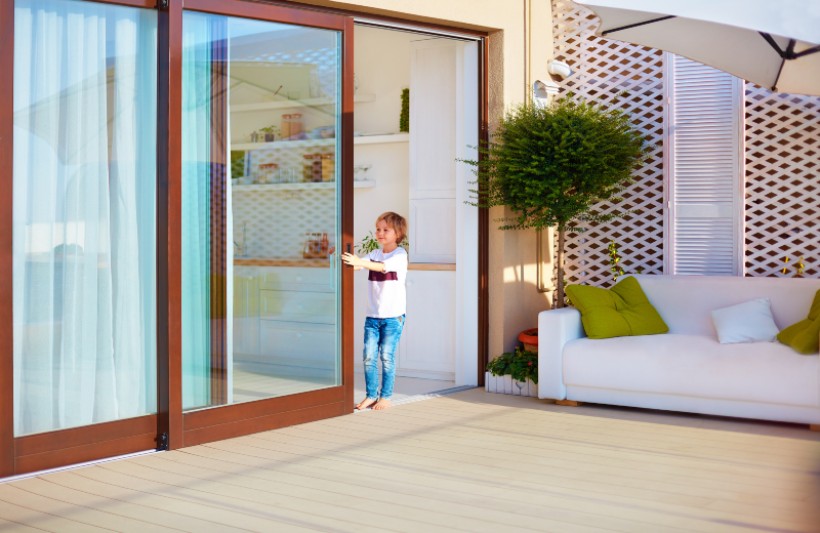 A small girl playing with the Automatic sliding door at home